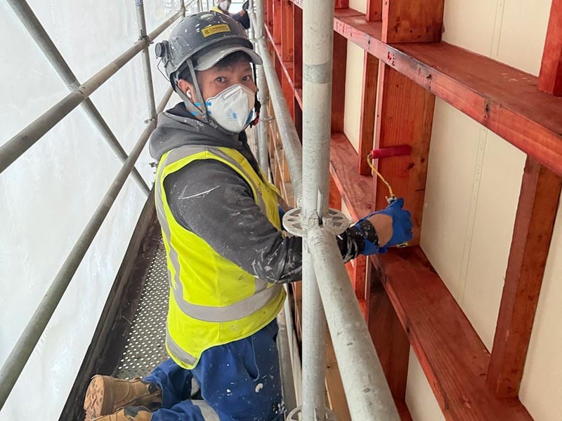 cassidy team member treating timber framing on site