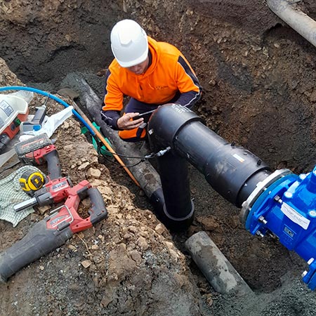 worker checking joins in water pipework